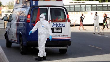 A first responder wearing a protective suit arrives to take a patient, following the outbreak of the coronavirus disease (COVID-19), in the Al Quoz industrial district of Dubai. (Reuters)