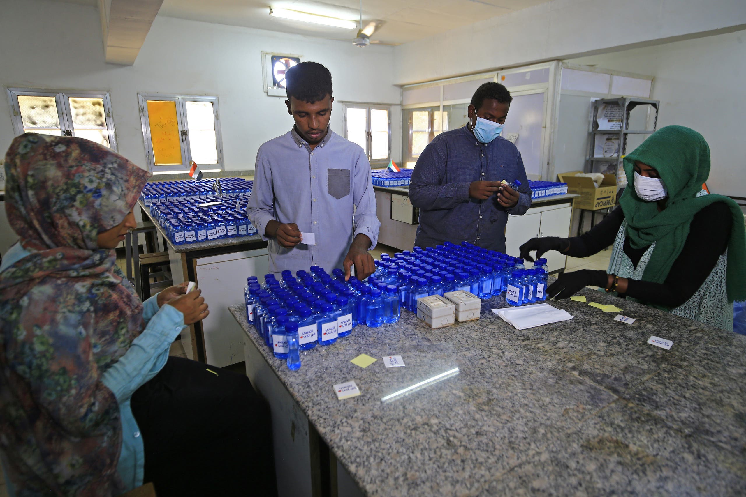 Sudanese medical laboratory students prepare sterilisers to combat the spread of the coronavirus COVID-19 in Khartoum. (AFP)