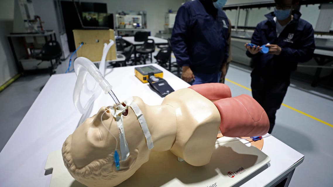 The prototype for a low-cost ventilator for patients with COVID-19 is calibrated by engineering professors from La Sabana University, Julian Echeverry, left, and Andres Ramirez, in Bogota on April 14, 2020. (AP)