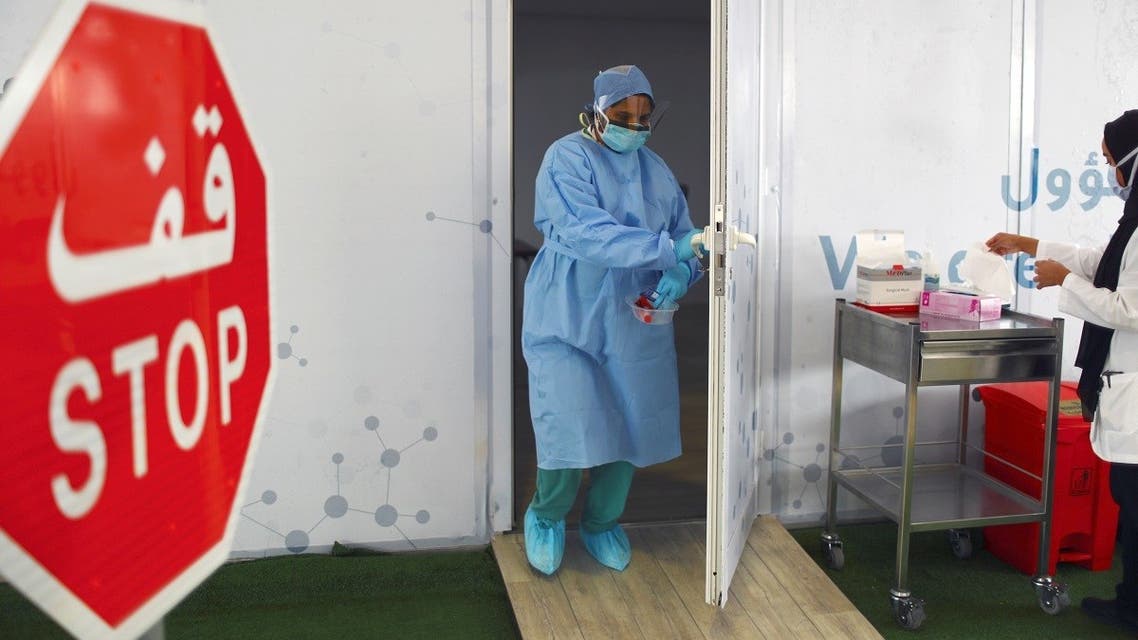 A member of medical staff carries a swab tested during drive-thru coronavirus disease testing (COVID-19) at a screening centre in Abu Dhabi, United Arab Emirates March 30, 2020. (Reuters)