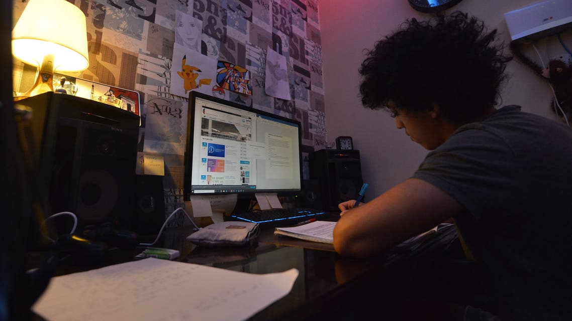 Foreign student Amro, attending the French International Lycée in Riyadh, studies at home on March 23, 2020 as schools in Saudi Arabia are closed amidst the coronavirus pandemic. (AFP)