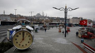 A clock showing the time at noon, is displayed for a photo at Eminonu district during the coronavirus disease (COVID-19) outbreak, in Istanbul,Turkey, March 31, 2020. (Reuters)