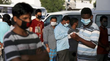 Foreign workers wearing protective face masks queue outside a corner store, following the outbreak of the coronavirus disease (COVID-19), in the Al Quoz industrial district of Dubai, United Arab Emirates, April 14, 2020.  (Reuters)