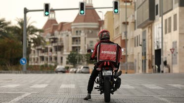 A delivery man drives a motorcycle, following the outbreak of coronavirus disease (COVID-19), in Dubai, United Arab Emirates, March 27, 2020. (Reuters)