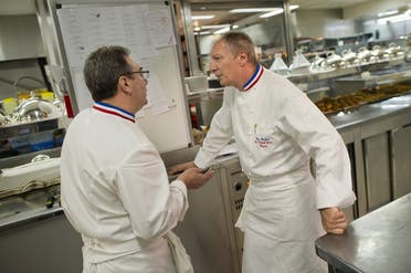Head chef of the five-star luxury hotel Le Bristol in Paris Eric Frechon (R) speaks with his sous-chef Franck Leroy in the hotel’s kitchen. (AFP)