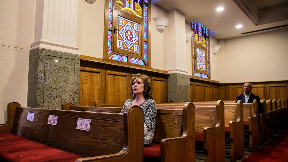 A Christian Egyptian woman attends a sparsely attended Bright Saturday service amid the COVID-19 pandemic at a church in the capital Cairo on April 18, 2020. (AFP)