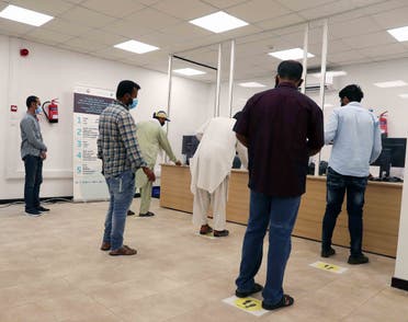 Workers queue at the new facility. (WAM)