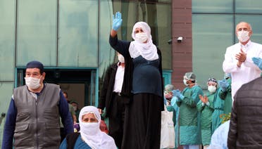 Patients are applauded by medical staff members as they leave the Dicle University Hospital after recovering from the coronavirus disease (COVID-19), in Diyarbakir, Turkey, on April 15, 2020. (Reuters)