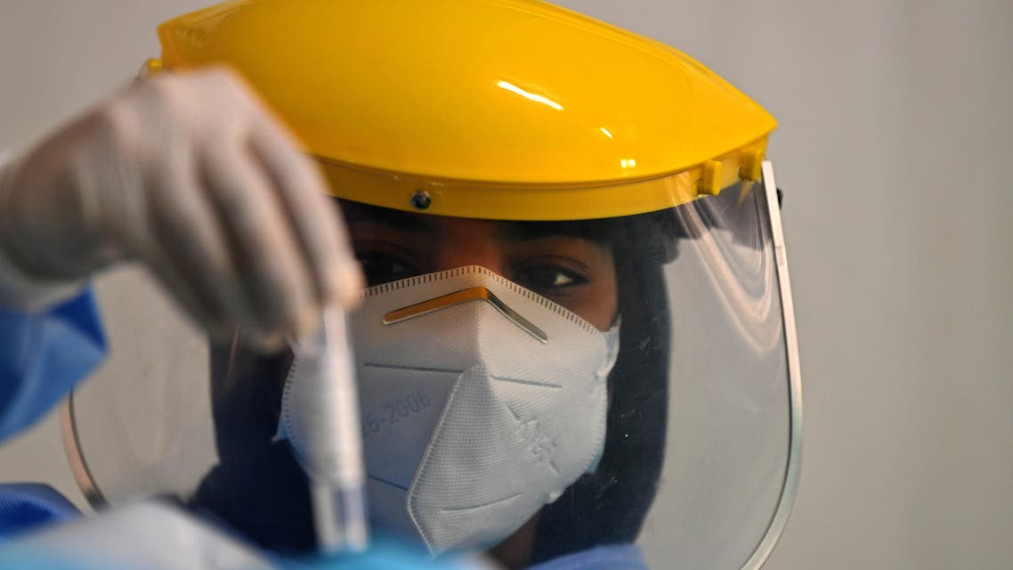 A health worker looks at a sample taken from a foreign worker to check for the novel coronavirus at a testing centre in the Al Quaz area of Dubai, in the United Arab Emirates, on April 18, 2020. 