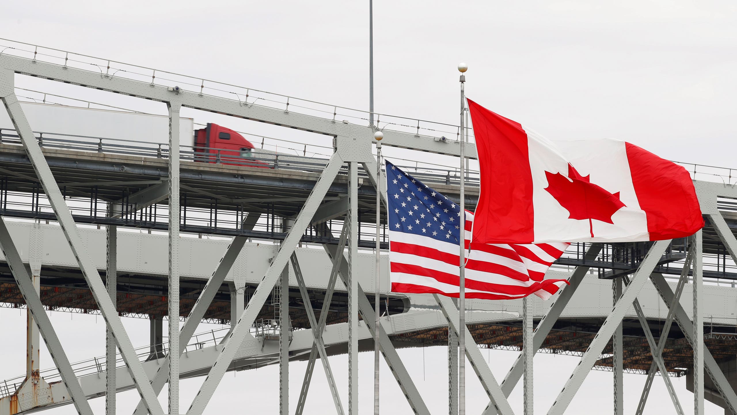 A truck crosses the Blue Water Bridge into Port Huron, Mich., from Sarnia, Ontario, Canada, Wednesday, March 18, 2020. (AP)