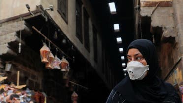 A woman wearing a protective face mask, amid concerns over the coronavirus, looks at traditional Ramadan lanterns, ahead of the Muslim holy month of Ramadan at Al Khayamia street in old Cairo, Egypt, April 16, 2020. (Reuters)