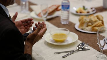 A Muslim man breaks his fast at a ceremony during the Muslim fasting month of Ramadan in Cologne. (Reuters)