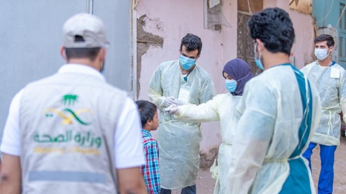Medical health workers in Saudi Arabia check the temperature of a young boy. (Twitter)