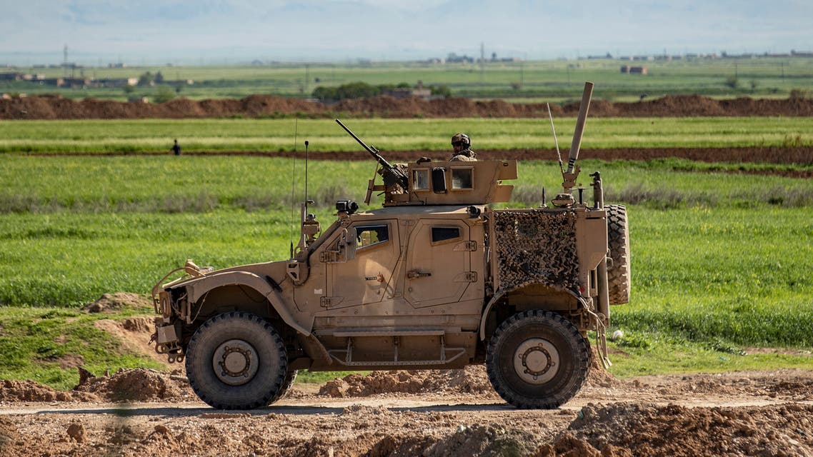 A US military vehicle, part of a convoy, advances near the town of Tal Tamr in the northeastern Syrian Hasakeh province, by the border with Turkey, on April 14, 2020. 