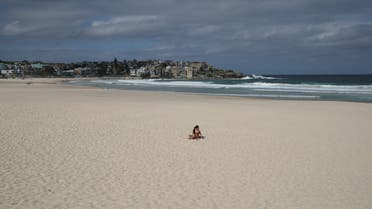 Single surfer on Australia's Bondi Beach after it was closed due to coronavirus. (Reuters)