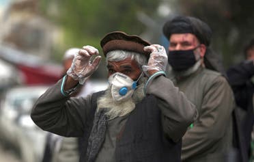 Daily-wage workers wear a protective face mask to help curb the spread of the coronavirus in Kabul, Afghanistan, Monday, April 20, 2020. (AP)