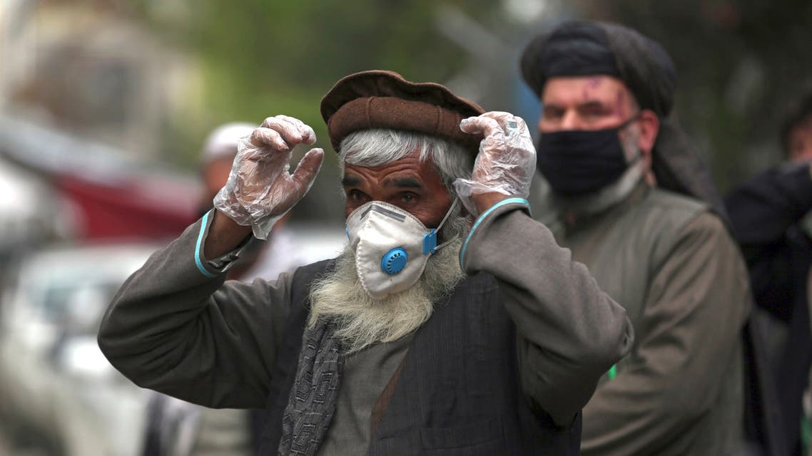 Daily-wage workers wear a protective face mask to help curb the spread of the coronavirus in Kabul, Afghanistan, Monday, April 20, 2020. (AP)