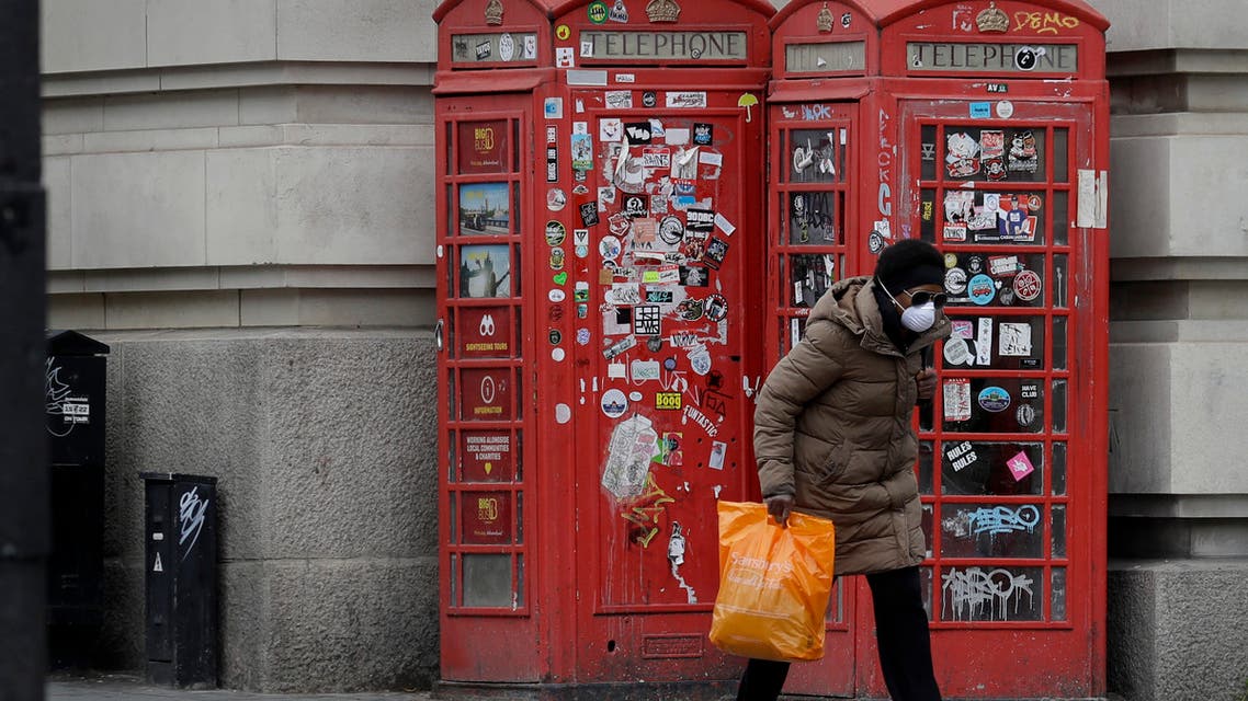 A woman wears a protective mask to protect from coronavirus, in Westminster as the country continues its lockdown in an attempt to control the spread of the coronavirus, in London on April 18, 2020. (AP)