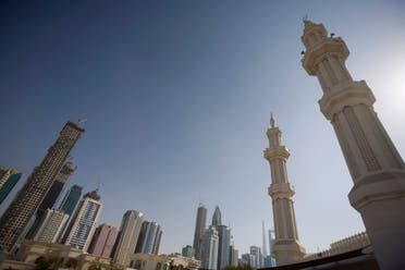 Minarets on a mosque are seen behind the booming real estate projects on the Sheikh Zayed highway in Dubai. (Reuters)