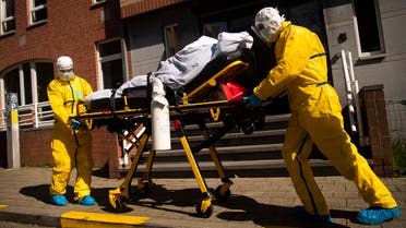 A coronavirus patient is transferred from a hospital to a home for elderly by members of the medical staff of Klinicare in Brussels on April 1, 2020. (AP)