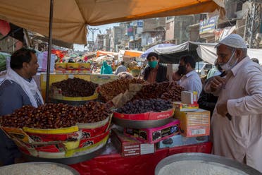 Consumers buy dates for the upcoming fasting month of Ramadan, during a lockdown to contain the spread of coronavirus, in Rawalpindi, Pakistan, on Tuesday, April 21, 2020. (AP)