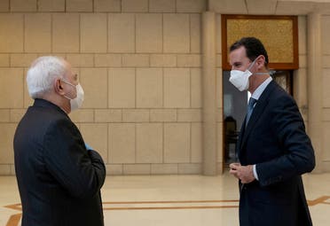 بشار الأسد ومحمد جواد ظريف (رويترز)