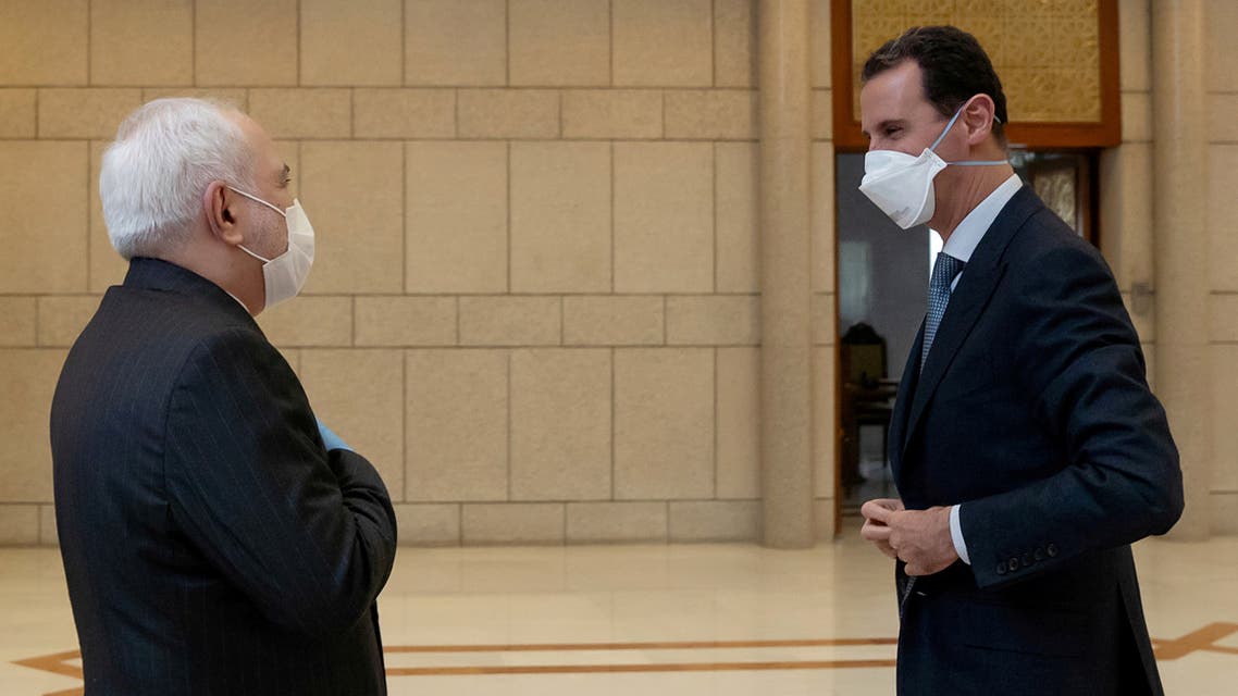 بشار الأسد ومحمد جواد ظريف (رويترز)