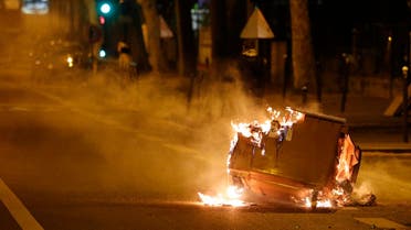 A trash bin burns in the street during clashes in Villeneuve-la-Garenne, in the northern suburbs of Paris, early on April 21, 2020. (AFP)