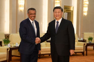 World Health Organization director general Tedros Adhanom (L) shakes hands with Chinese President Xi Jinping at the Great Hall of the People in Beijing on January 28, 2020. (AFP)