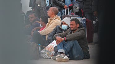 Tunisian workers who were stranded in Libya are pictured as they return to Tunisia at the Ras Jedir border post on April 20, 2020.  (AFP)
