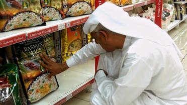 An Emirati man reads the front of a package of Indian Basmati rice in a supermarket in Dubai on July 19, 2008. (AFP)