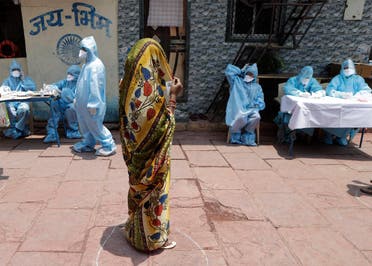 A woman waits for her turn for a free medical check in Dharavi, one of Asia’s largest slums, during lockdown to prevent the spread of the new coronavirus in Mumbai, India, on April 18, 2020. (AP)