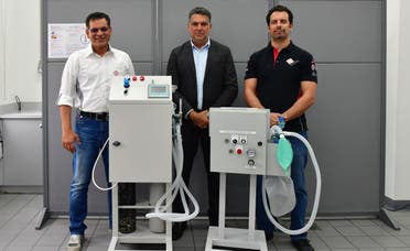 Bahrain International Circuit engineers pictured with one unit of the newly designed breathing aid. (BNA)