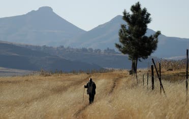 A man walks on the land at Ha Mampho village, in Lesotho on June 3, 2017. (AP)