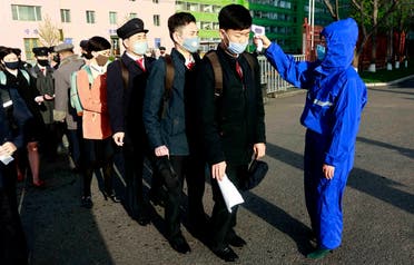 Students wearing facemasks have their temperature checked as a precaution against a new coronavirus as their university reopened following vacation, at Kim Chaek University of Technology in Pyongyang on April 22, 2020. (AP)