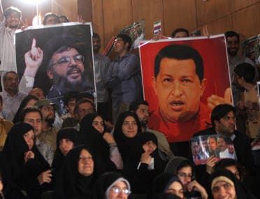 Iranian students hold a poster of Lebanese Hassan Nasrallah, the secretary general of Hezbollah, left, and Venezuela's then-President Hugo Chavez at Tehran University in Iran. (File photo: AP)