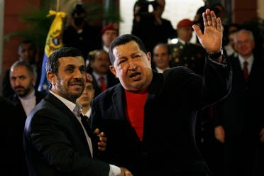  Iran's President Mahmoud Ahmadinejad, left, shakes hands with Venezuela's President Hugo Chavez as he arrives to Miraflores presidential palace in Caracas, Venezuela on June 22, 2012. (AP)