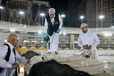 The General Presidency for the Affairs of the Two Holy Mosques's team cleans and sterilizes the cover (Kiswa) and surface of the Holy Kaaba in Mecca, Saudi Arabia, April 21, 2020. (Twitter) 5