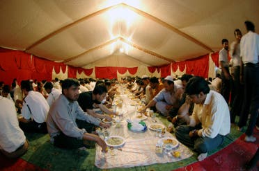 Muslim labourers and workers prepare to break their fast during Ramadan in a charity tent set up to offer free iftar meals to poor working labourers in one of the residential areas in Dubai, UAE. (File photo: Reuters)