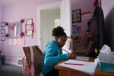 Elementary school fourth-grader Miriam Amacker does school work in her room at her family's home in San Francisco on April 9, 2020. (AP)