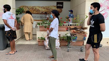 People keep distance in a line outside a supermarket to prevent the spread of the coronavirus disease (COVID-19) in Dubai, United Arab Emirates. (Reuters)