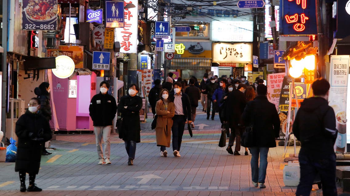 People wearing face masks to protect themselves against contracting the coronavirus disease (COVID-19), walk on a street in central Seoul, South Korea April 22, 2020. REUTERS/Heo Ran