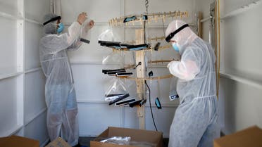 Create 180 employees wearing protective equipment package face shields, amid the coronavirus disease (COVID-19) outbreak, in London, Britain April 21, 2020. REUTERS/Henry Nicholls