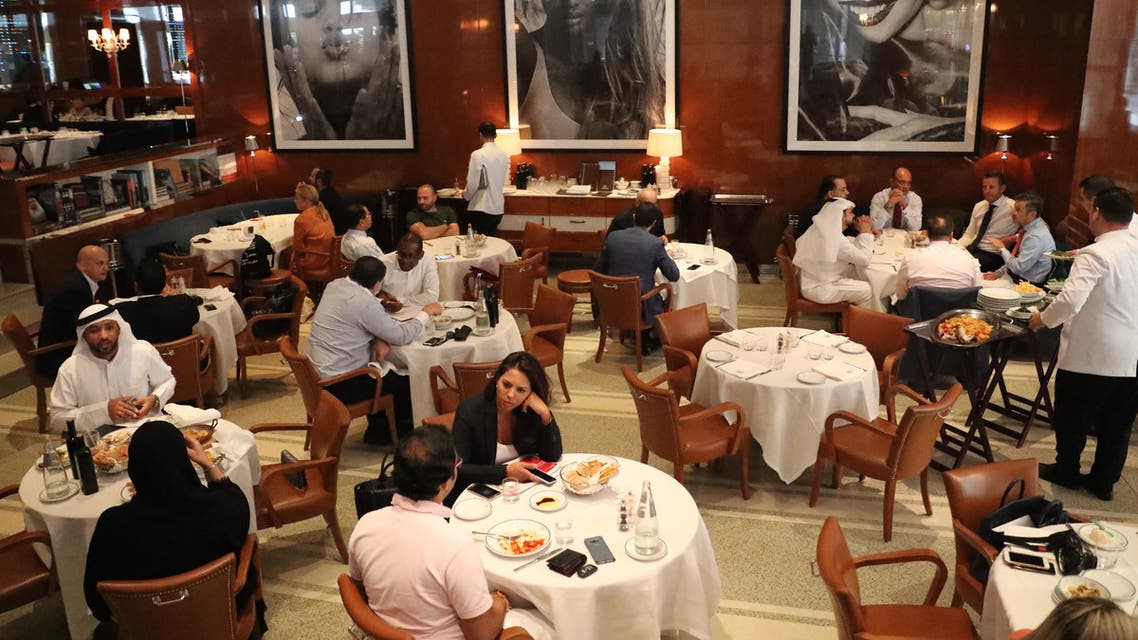 Peope eat at a restaurant in Dubai on August 30, 2018. (AFP)