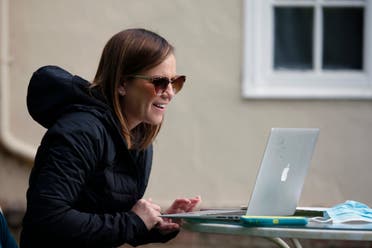 Kelly Dighero, a 3rd grade teacher at Phoebe Hearst Elementary School, holds her first online meeting with students and parents on the front lawn of her home in Sacramento, Calif. on April 13, 2020. (AP)