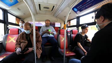 Iranian men keep distance from each other while waiting for the bus in Tehran on April 21, 2020 amid the coronavirus COVID-19 pandemic. (File photo)
