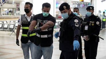 Police and civil aviation personnel wearing protective face masks work at the Kuwait Airport as the repatriation process of Kuwait citizens continues, following the outbreak of the coronavirus disease (COVID-19), in Kuwait City, Kuwait April 21, 2020. REUTERS/Stephanie McGehee