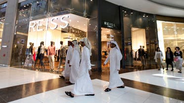 Men walk past a Reiss store at Dubai Mall shopping center in Dubai, February 5, 2012. (Reuters)
