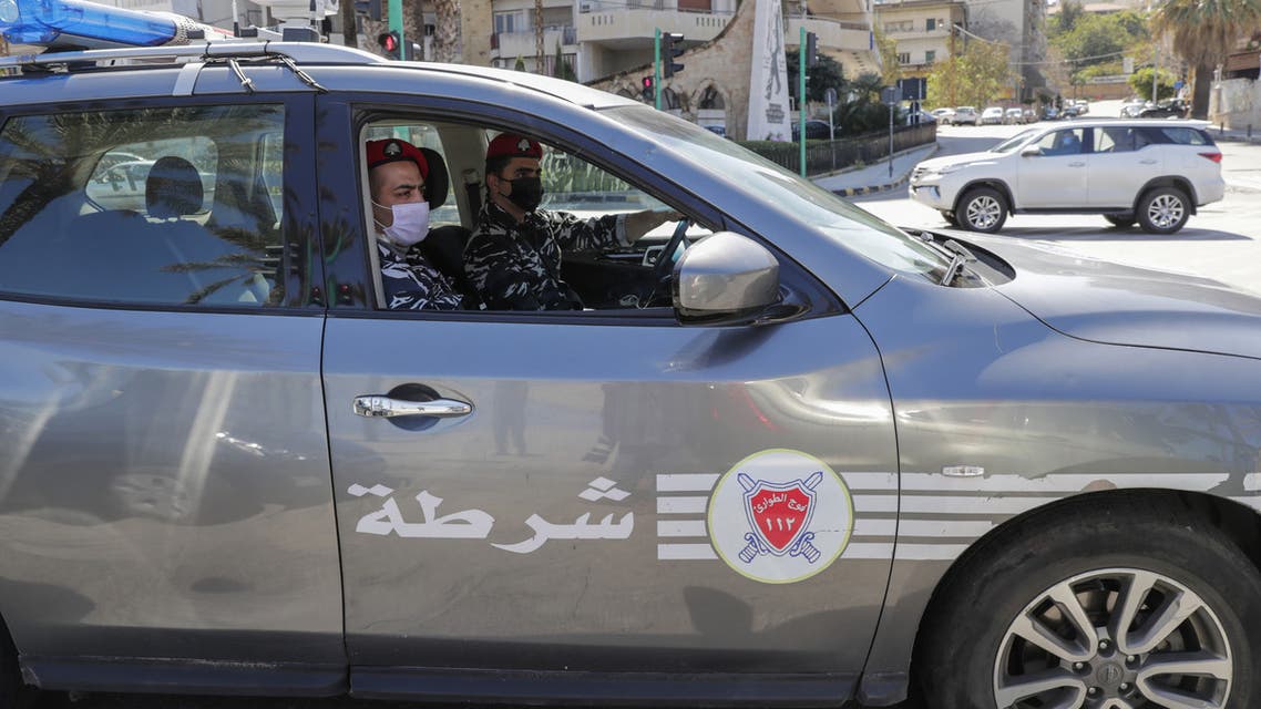 Police officers wearing face masks patrol in the Lebanese capital Beirut to help enforce the government's order for people to stay at home amid the coronavirus COVID-19 pandemic, on March 22, 2020. (AFP)