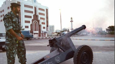 An Emirati policeman fires a cannon to announce the end of a day long of fasting in Sharjah